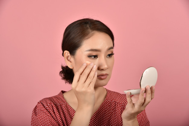 asian-woman-looking-her-facial-problem-mirror-female-feeling-annoy-about-her-reflection-appearance-show-aging-skin-signs-makeup-cover-skin-problem_175175-175